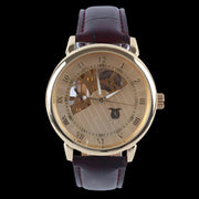Luxury gold-tone watch with a skeleton dial and leather strap, showcasing refined craftsmanship and style.